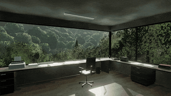 A concrete studio overlooking a green, wooded valley